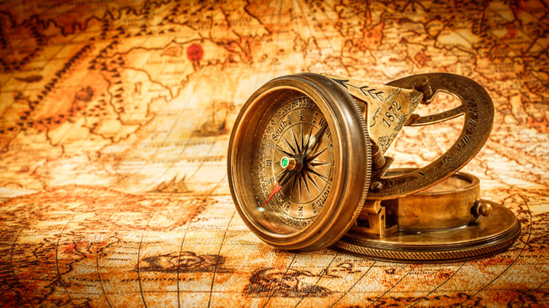 Vintage still life. Vintage compass lies on an ancient world map in 1565.
